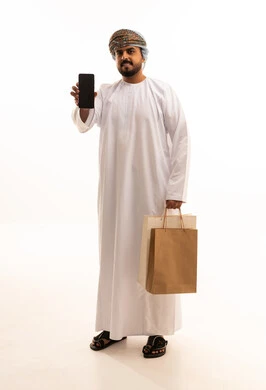 Omani Man with Smartphone and Shopping Bags in Studio