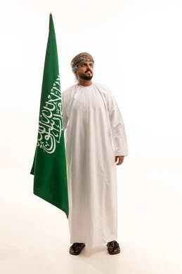 Omani Man Holding Saudi Arabian Flag in Studio