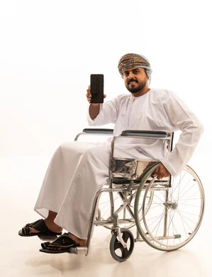 Omani Man in Wheelchair Holding Smartphone Studio