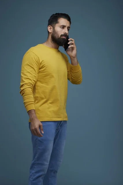 Saudi Man Talking on Smartphone in Yellow Shirt