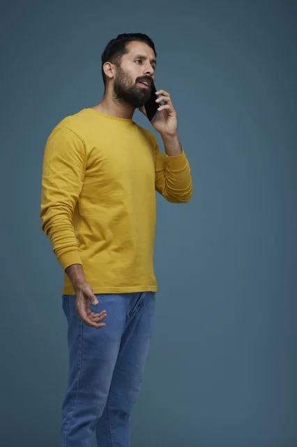 Saudi Man Talking on Smartphone in Yellow Casual Shirt