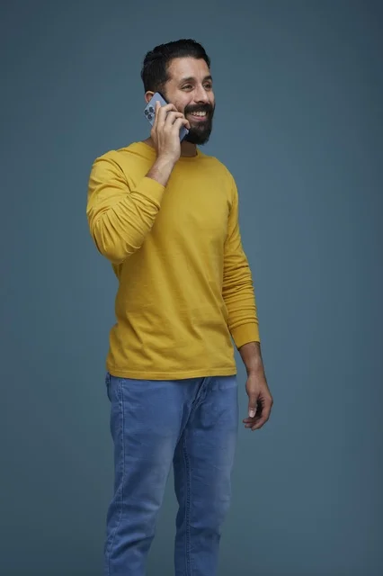 Saudi Man Talking on Smartphone in Yellow Shirt