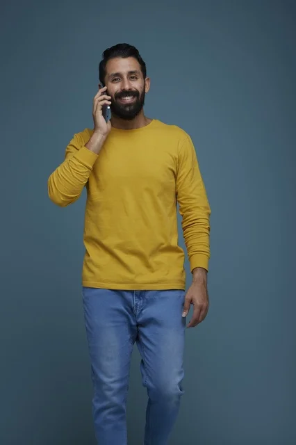 Saudi Man Talking on Smartphone in Casual Yellow Shirt