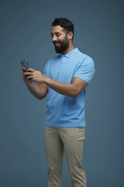 Saudi Man Using Smartphone in Blue Studio Background