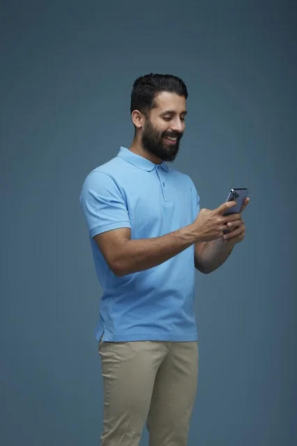 Saudi Man Using Smartphone in Casual Clothing