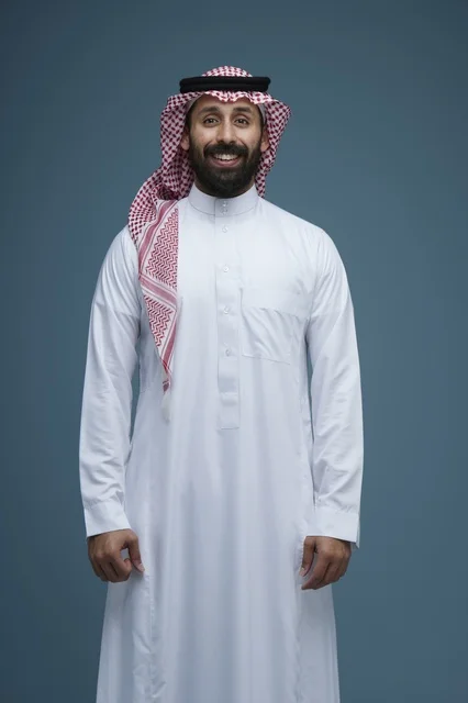 Saudi Man in Traditional Dress Smiling in Studio Portrait