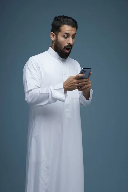 Shocked Saudi Man with Smartphone in Studio