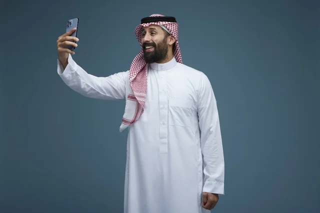 رجل سعودي يلتقط صورة سيلفي بالهاتف الذكي