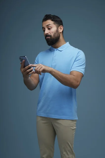 Middle Eastern Man Using Smartphone in Casual Attire
