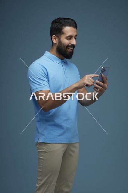 Saudi Man Using Smartphone Wearing Casual Blue Polo Shirt