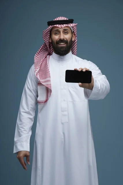 Saudi Man Holding Smartphone on Blue Background