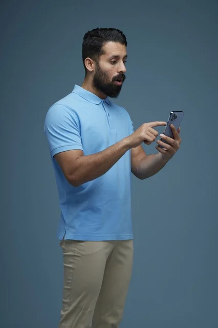 Saudi Man Using Smartphone with Shocked Face Expression