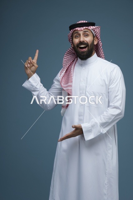 رجل سعودي يشير بيده للأعلى بتعبيرات وجه متحمسة ومندهشة