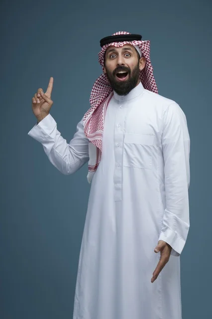 Saudi Man Pointing Up with Surprised Face Studio Shot