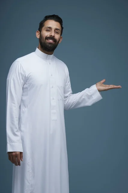 Saudi Man in Traditional Thobe Pointing at Studio