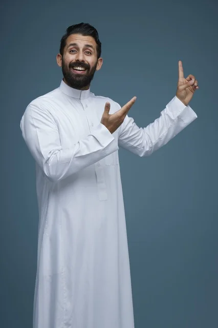 Saudi Man in Traditional Thobe Pointing in Studio