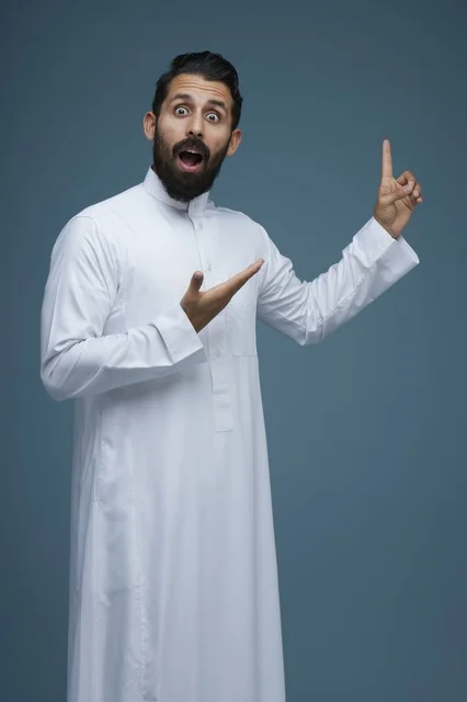 Surprised Saudi Man Pointing Upward in White Thobe