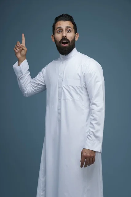 Saudi Man in White Thobe Pointing Up with Surprised Look