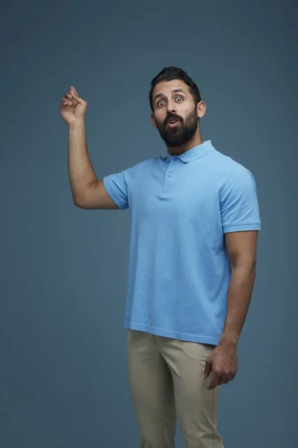 Surprised Saudi Man Gesturing in Blue Polo Shirt