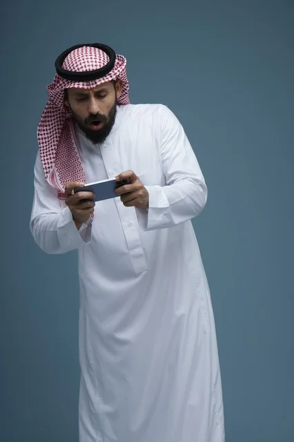 Saudi Man Playing Video Game on Smartphone Studio