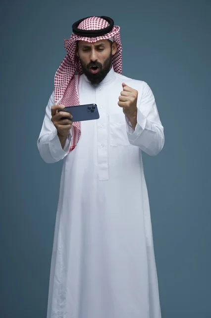 Saudi Man Playing Mobile Game on Smartphone