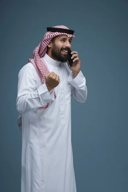 رجل سعودي يستخدم الهاتف الذكي بإيماءة النصر