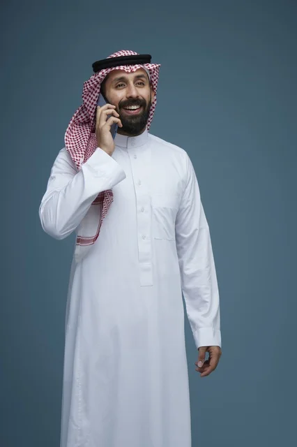 Saudi Man Talking on Smartphone in Traditional Thobe