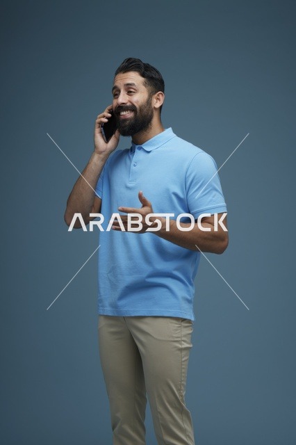 رجل سعودي يتحدث بالهاتف بملابس كاجوال