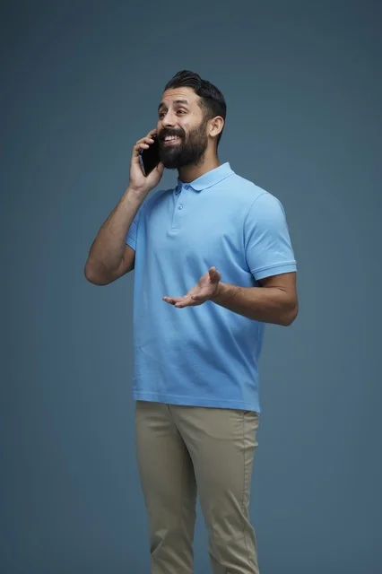 Saudi Man Talking on Smartphone in Casual Attire