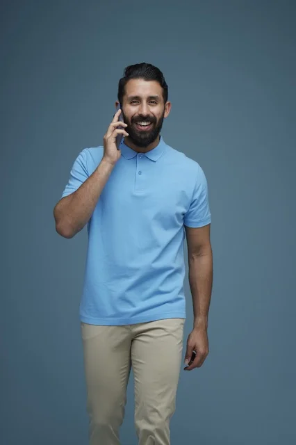 Saudi Man in Casual Clothes Talking on Smartphone Studio