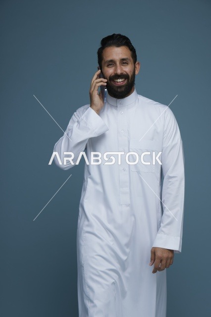 Smiling Saudi Man Talking on Smartphone in Studio