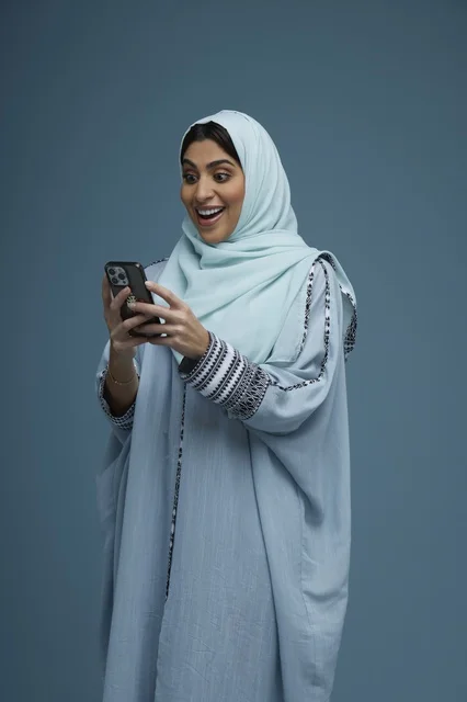 Excited Saudi Woman Reacting to Smartphone