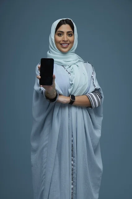 Saudi Woman Holding Smartphone in Studio Portrait