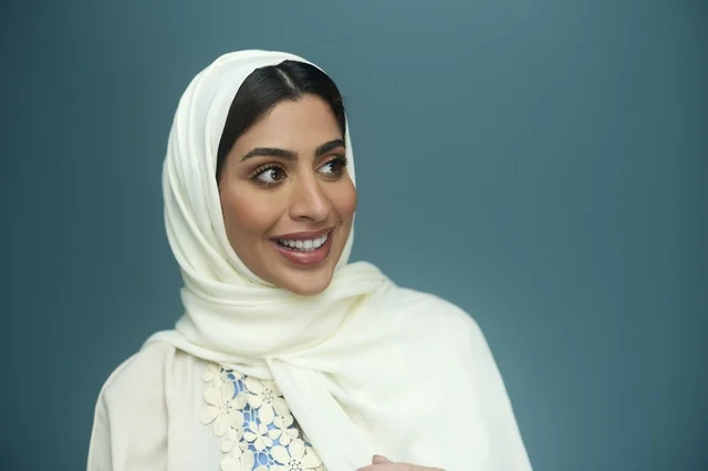 Saudi Woman in White Hijab Smiling in Studio Portrait