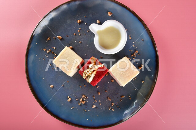 A close-up of a plate of cake sweets in different shapes and flavors next to the sauce, oriental sweets, Ramadan sweets, sweets and sugars, delicious candy pieces, sweets, delicious cold sweets, colorful background