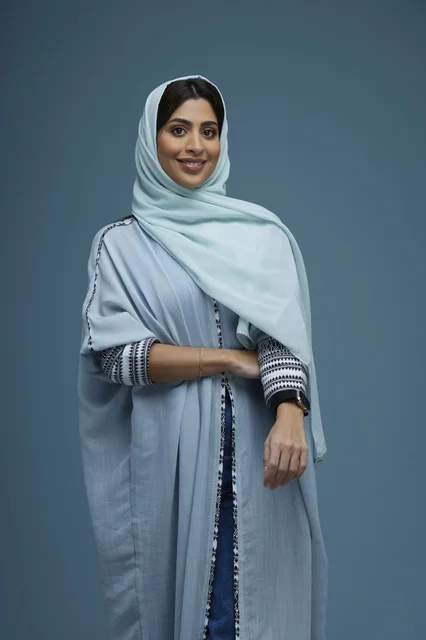 Smiling Saudi Woman in Blue Abaya Studio Portrait