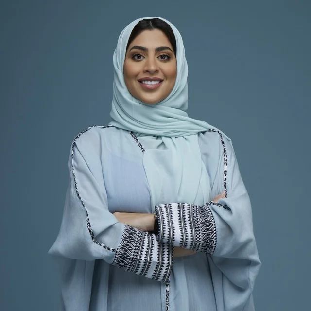 امرأة سعودية بالعباءة الزرقاء والحجاب في الاستوديو