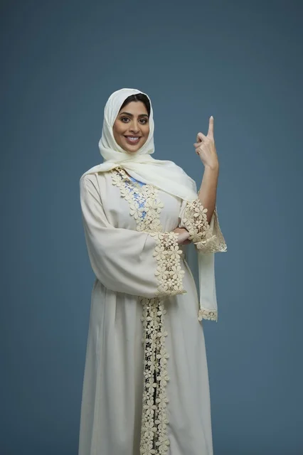 Saudi Woman in White Abaya Pointing Upward