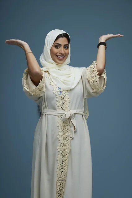 Saudi Woman in Hijab Smiling with Presentation Gesture