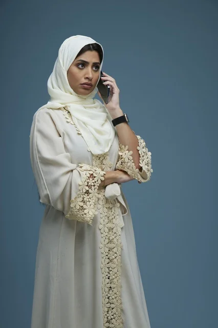 Saudi Woman in Embroidered Abaya Calling on Smartphone