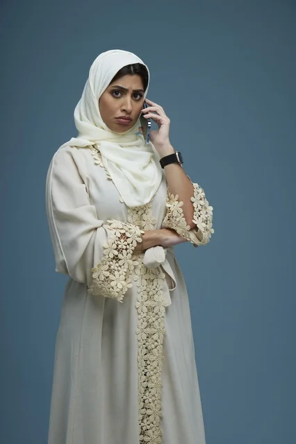 Saudi Woman in Embroidered Abaya Talking on Phone Studio