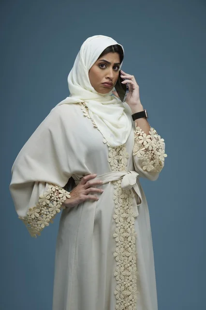Saudi Woman in Embroidered Abaya Calling on Smartphone