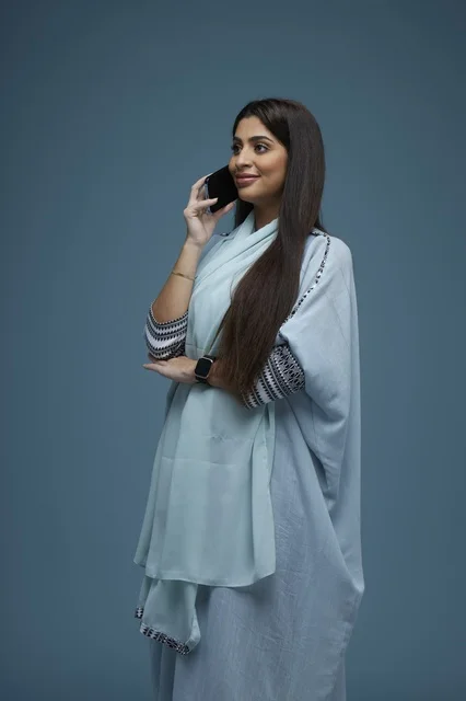 Saudi Woman with Long Hair Talking on Smartphone Studio