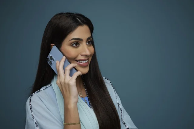 Saudi Woman Talking on Smartphone in Studio