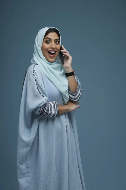 Saudi Woman in Hijab Talking on Smartphone with Surprised Face