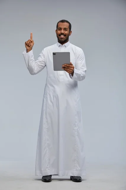 Saudi Man in Thobe Using Tablet Pointing Up