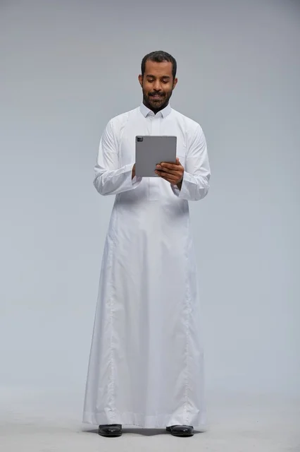 Saudi Man in White Thobe Using Digital Tablet Studio