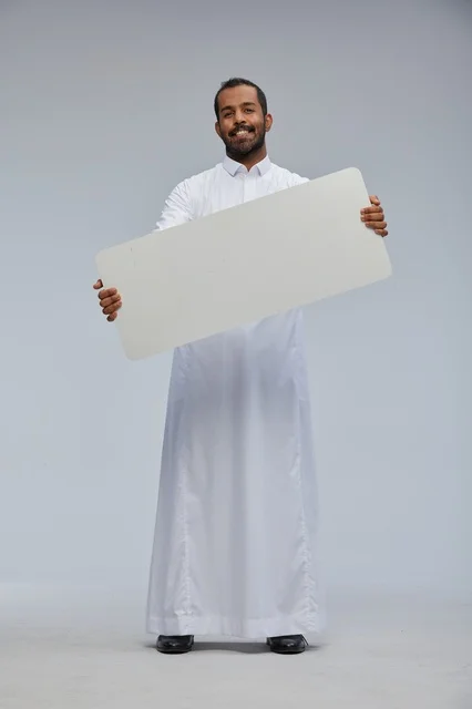 Saudi Man in Thobe Holding Blank White Sign
