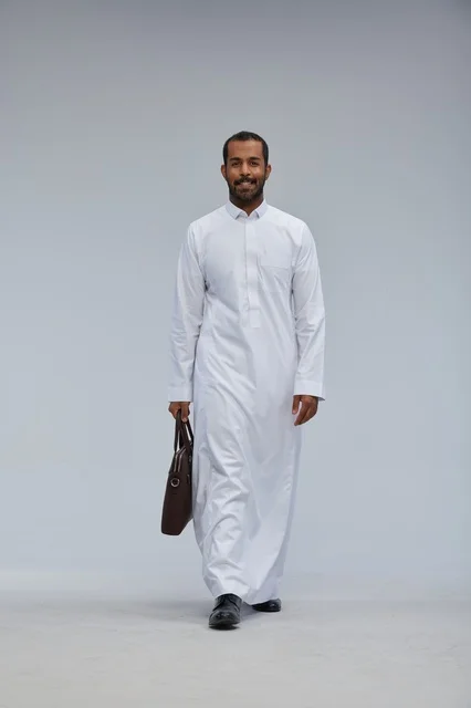 رجل أعمال سعودي بالزي التقليدي يحمل حقيبة عمل