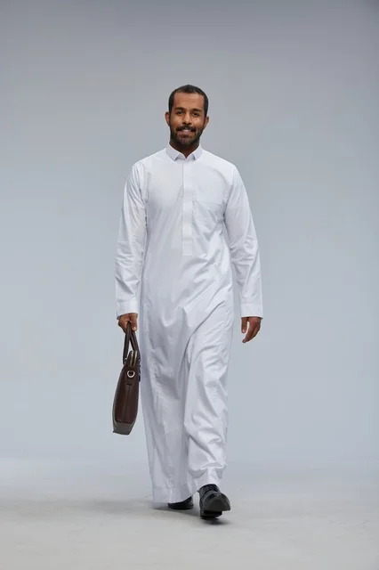 Saudi Businessman in White Thobe Walking with Briefcase